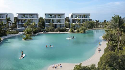 Swimmers on Lunaya's beach lagoon with the villas behind